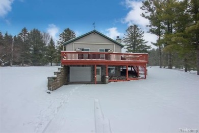 Welcome to this inviting raised ranch style home nestled within on Lost Lake Woods Club in Michigan - for sale on GolfHomes.com, golf home, golf lot