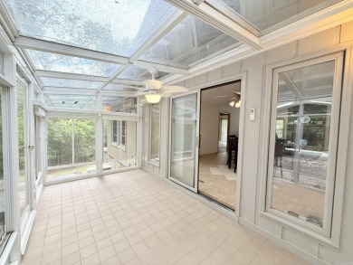 Enclosed glass sunroom offers year-round enjoyment from this on Cortez Golf Course in Arkansas - for sale on GolfHomes.com, golf home, golf lot