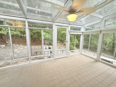Enclosed glass sunroom offers year-round enjoyment from this on Cortez Golf Course in Arkansas - for sale on GolfHomes.com, golf home, golf lot