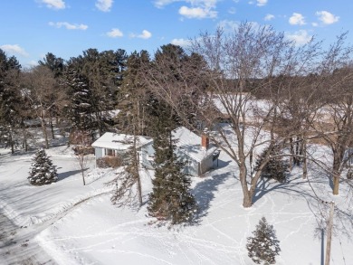 This charming 1.5-story home offers water access to Lake Iola on Glacier Wood Golf Club in Wisconsin - for sale on GolfHomes.com, golf home, golf lot