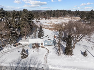 This charming 1.5-story home offers water access to Lake Iola on Glacier Wood Golf Club in Wisconsin - for sale on GolfHomes.com, golf home, golf lot