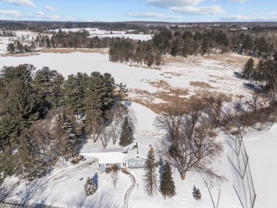 This charming 1.5-story home offers water access to Lake Iola on Glacier Wood Golf Club in Wisconsin - for sale on GolfHomes.com, golf home, golf lot