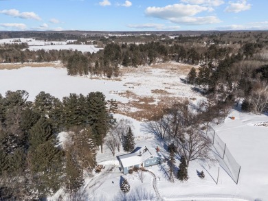 This charming 1.5-story home offers water access to Lake Iola on Glacier Wood Golf Club in Wisconsin - for sale on GolfHomes.com, golf home, golf lot