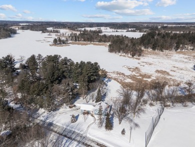 This charming 1.5-story home offers water access to Lake Iola on Glacier Wood Golf Club in Wisconsin - for sale on GolfHomes.com, golf home, golf lot