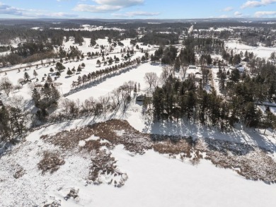 This charming 1.5-story home offers water access to Lake Iola on Glacier Wood Golf Club in Wisconsin - for sale on GolfHomes.com, golf home, golf lot