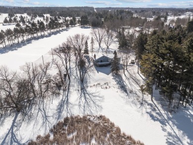 This charming 1.5-story home offers water access to Lake Iola on Glacier Wood Golf Club in Wisconsin - for sale on GolfHomes.com, golf home, golf lot