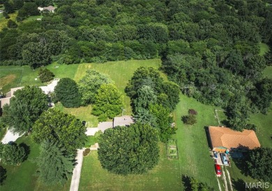 This stunning 2-story home offers 4 bedrooms, 2 full baths, and on Oak Meadow Country Club in Missouri - for sale on GolfHomes.com, golf home, golf lot