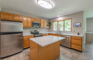 This stunning 2-story home offers 4 bedrooms, 2 full baths, and on Oak Meadow Country Club in Missouri - for sale on GolfHomes.com, golf home, golf lot