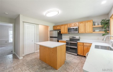 This stunning 2-story home offers 4 bedrooms, 2 full baths, and on Oak Meadow Country Club in Missouri - for sale on GolfHomes.com, golf home, golf lot
