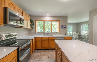 This stunning 2-story home offers 4 bedrooms, 2 full baths, and on Oak Meadow Country Club in Missouri - for sale on GolfHomes.com, golf home, golf lot