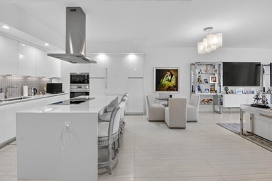 Dazzling golf and sparkling lake views await in this stunning on Boca West Golf and Country Club in Florida - for sale on GolfHomes.com, golf home, golf lot