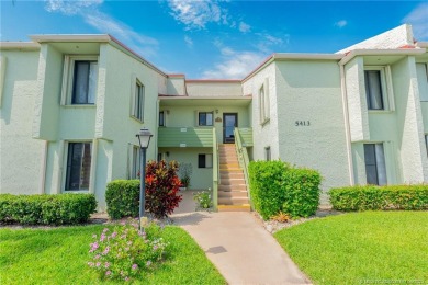 Imagine living in this secure 2nd floor condo overlooking the on Miles Grant Country Club in Florida - for sale on GolfHomes.com, golf home, golf lot