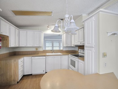 Welcome Home to this charming LAND OWNED 2/2 with a 2020 roof on Spanish Lakes Golf Village in Florida - for sale on GolfHomes.com, golf home, golf lot