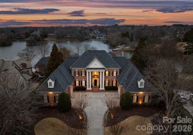Stunning lakefront home in the exclusive gated community of on Carmel Country Club in North Carolina - for sale on GolfHomes.com, golf home, golf lot