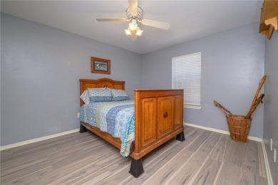 Nestled beneath large shade oak trees, this fully furnished on Rockport Country Club in Texas - for sale on GolfHomes.com, golf home, golf lot