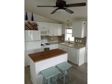Beautiful cozy waterfront home in Village green Community.  This on Vista Plantation Golf Club in Florida - for sale on GolfHomes.com, golf home, golf lot
