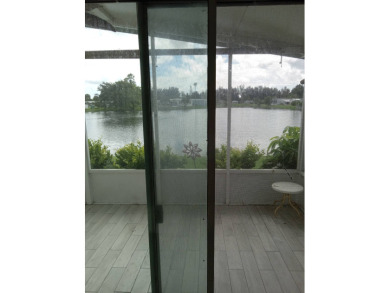Beautiful cozy waterfront home in Village green Community.  This on Vista Plantation Golf Club in Florida - for sale on GolfHomes.com, golf home, golf lot