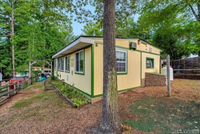 Cozy and character-filled nestled in a quiet lake community just on River Ridge Golf Club in Virginia - for sale on GolfHomes.com, golf home, golf lot