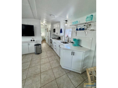 Cute and nicely updated park model featuring large full length on Long Island Golf Course in Texas - for sale on GolfHomes.com, golf home, golf lot