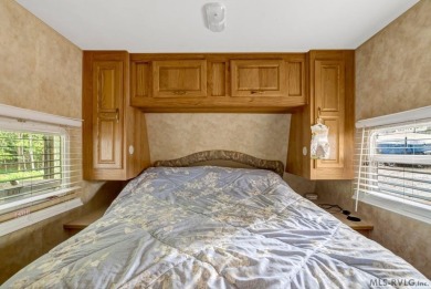 Enjoy the perfect blend of comfort and recreation in this 2 bed on River Ridge Golf Club in Virginia - for sale on GolfHomes.com, golf home, golf lot