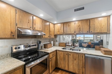 Live the Florida dream in your new move-in ready corner unit on Isla Del Sol Yacht and Country Club in Florida - for sale on GolfHomes.com, golf home, golf lot