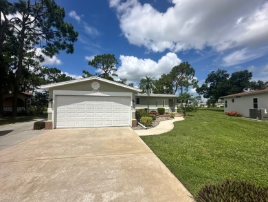 This beautiful Palm Harbour stucco home is located on the golf on Del Tura Golf and Country Club in Florida - for sale on GolfHomes.com, golf home, golf lot