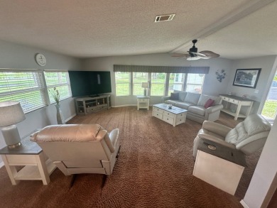 This beautiful Palm Harbour stucco home is located on the golf on Del Tura Golf and Country Club in Florida - for sale on GolfHomes.com, golf home, golf lot