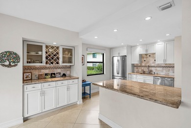 Exceptional golf course views wrap around this renovated on Quail Ridge Golf Course and Country Club in Florida - for sale on GolfHomes.com, golf home, golf lot