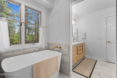 Welcome to this beautifully updated single-level home, perfectly on Pinewild Country Club of Pinehurst in North Carolina - for sale on GolfHomes.com, golf home, golf lot