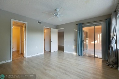 A breathtaking view and a peaceful living environment where life on Wynmoor Golf Course in Florida - for sale on GolfHomes.com, golf home, golf lot