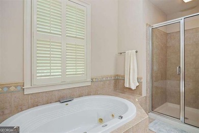 Discover timeless elegance and modern comfort in this on Woodmont Golf and Country Club in Georgia - for sale on GolfHomes.com, golf home, golf lot