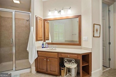 Discover timeless elegance and modern comfort in this on Woodmont Golf and Country Club in Georgia - for sale on GolfHomes.com, golf home, golf lot