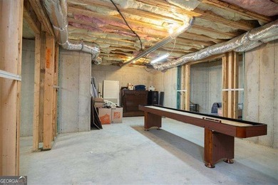 Discover timeless elegance and modern comfort in this on Woodmont Golf and Country Club in Georgia - for sale on GolfHomes.com, golf home, golf lot