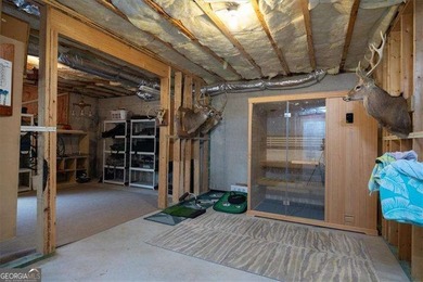 Discover timeless elegance and modern comfort in this on Woodmont Golf and Country Club in Georgia - for sale on GolfHomes.com, golf home, golf lot