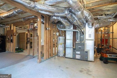 Discover timeless elegance and modern comfort in this on Woodmont Golf and Country Club in Georgia - for sale on GolfHomes.com, golf home, golf lot