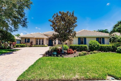 This stunning Mediterranean style stucco home is on a golf on Venetian Golf and River Club in Florida - for sale on GolfHomes.com, golf home, golf lot