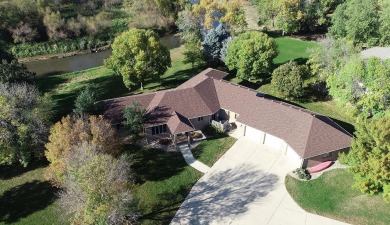 Immerse yourself in stunning river views from the large windows on Spencer Golf and Country Club in Iowa - for sale on GolfHomes.com, golf home, golf lot
