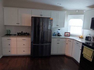 Great kitchen area with pass through counter and open walkway to on Four Lakes Golf Club in Florida - for sale on GolfHomes.com, golf home, golf lot