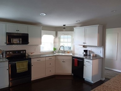 Great kitchen area with pass through counter and open walkway to on Four Lakes Golf Club in Florida - for sale on GolfHomes.com, golf home, golf lot