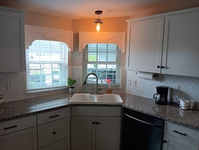 Great kitchen area with pass through counter and open walkway to on Four Lakes Golf Club in Florida - for sale on GolfHomes.com, golf home, golf lot