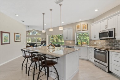 Enjoy stunning lake and golf course views framed by mature trees on Waterford Golf Club in Florida - for sale on GolfHomes.com, golf home, golf lot