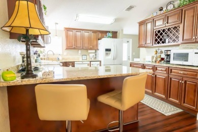 Nestled within the welcoming embrace of Whispering Pines in on Lily Lake Golf and RV Resort in Florida - for sale on GolfHomes.com, golf home, golf lot