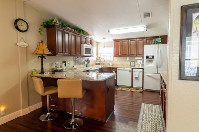 Nestled within the welcoming embrace of Whispering Pines in on Lily Lake Golf and RV Resort in Florida - for sale on GolfHomes.com, golf home, golf lot