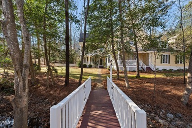 Don't miss walking over the bridge to this wonderful on Devils Ridge Golf Club in North Carolina - for sale on GolfHomes.com, golf home, golf lot