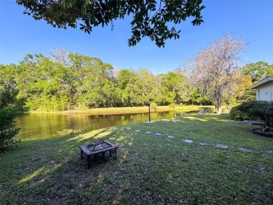 SERENITY AWAITS WITH THIS MOVE-IN READY home with private oasis on Seven Springs Golf and Country Club in Florida - for sale on GolfHomes.com, golf home, golf lot