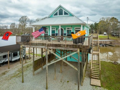 A river house with a view! This home offers 4 beds, 3 full baths on Tennessee River Golf Club in Tennessee - for sale on GolfHomes.com, golf home, golf lot