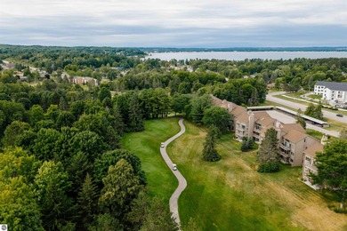 Perched above the third tee of Spruce Run Golf Course, this on Grand Traverse Resort and Spa in Michigan - for sale on GolfHomes.com, golf home, golf lot