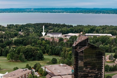 Perched above the third tee of Spruce Run Golf Course, this on Grand Traverse Resort and Spa in Michigan - for sale on GolfHomes.com, golf home, golf lot