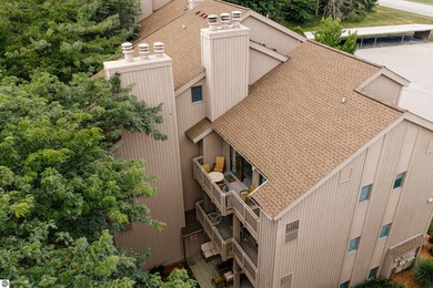 Perched above the third tee of Spruce Run Golf Course, this on Grand Traverse Resort and Spa in Michigan - for sale on GolfHomes.com, golf home, golf lot