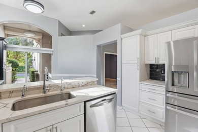 Enjoy relaxed South Florida living in this inviting 3-bedroom on Boca Delray Golf and Country Club in Florida - for sale on GolfHomes.com, golf home, golf lot